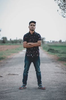 Young man standing confidently on a rural road in Darya Khan, Punjab, Pakistan.