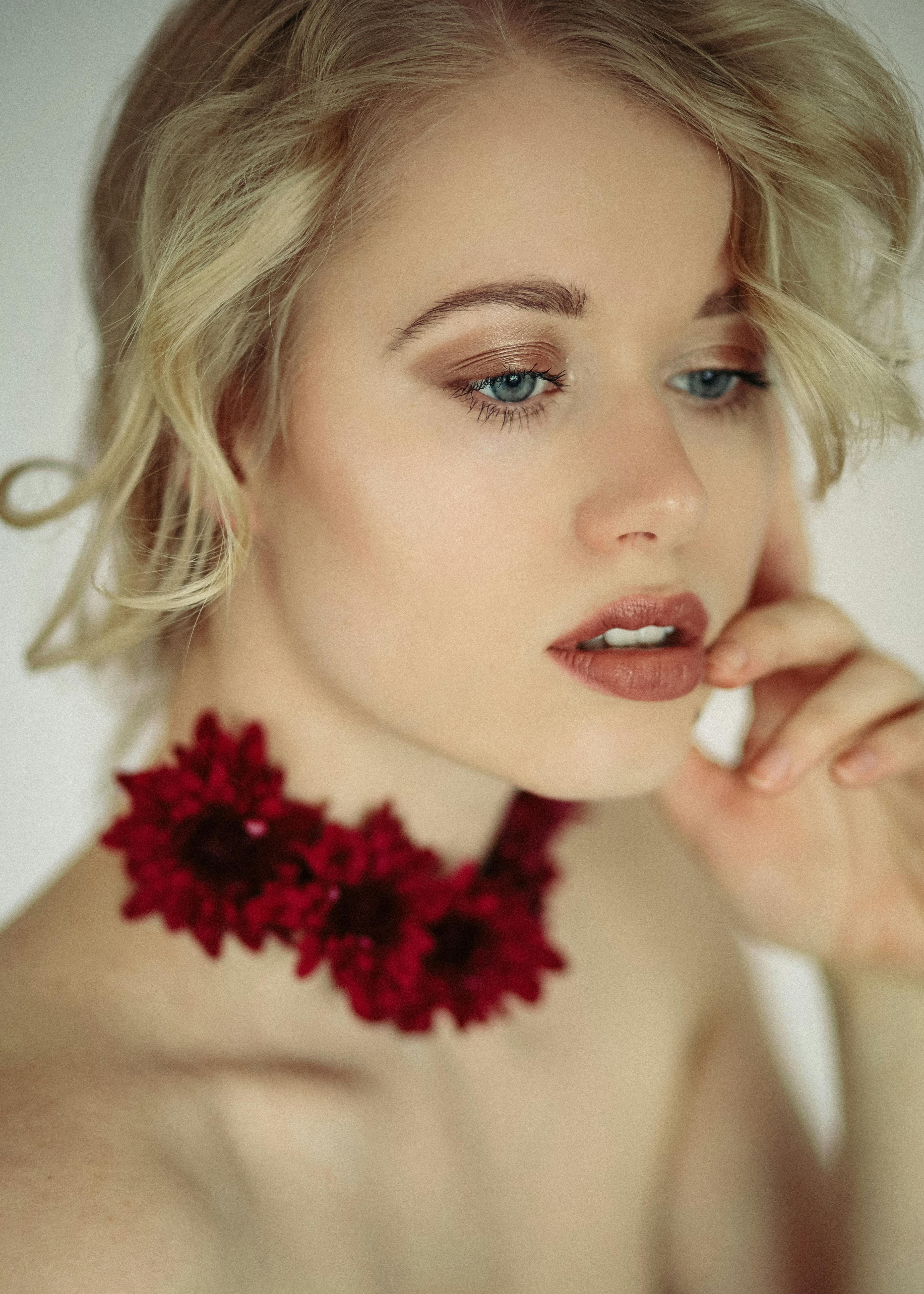 gentle woman with floral accessory and makeup