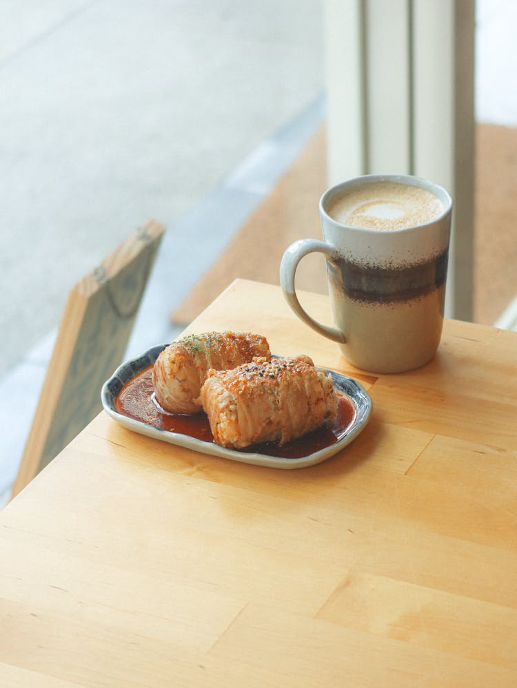 A Delicious Food On Tray Beside A Mug Of Coffee