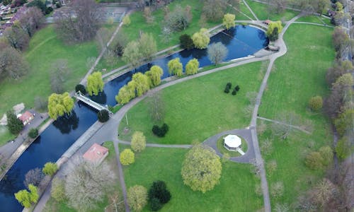 High Angle View of a Green Park with a Pond