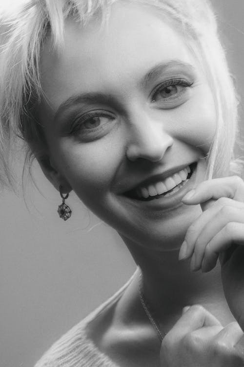 Grayscale Photo of a Pretty Woman Smiling