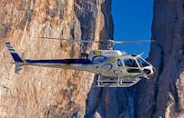 Selective Photograph of White Helicopter Near Brown Mountains