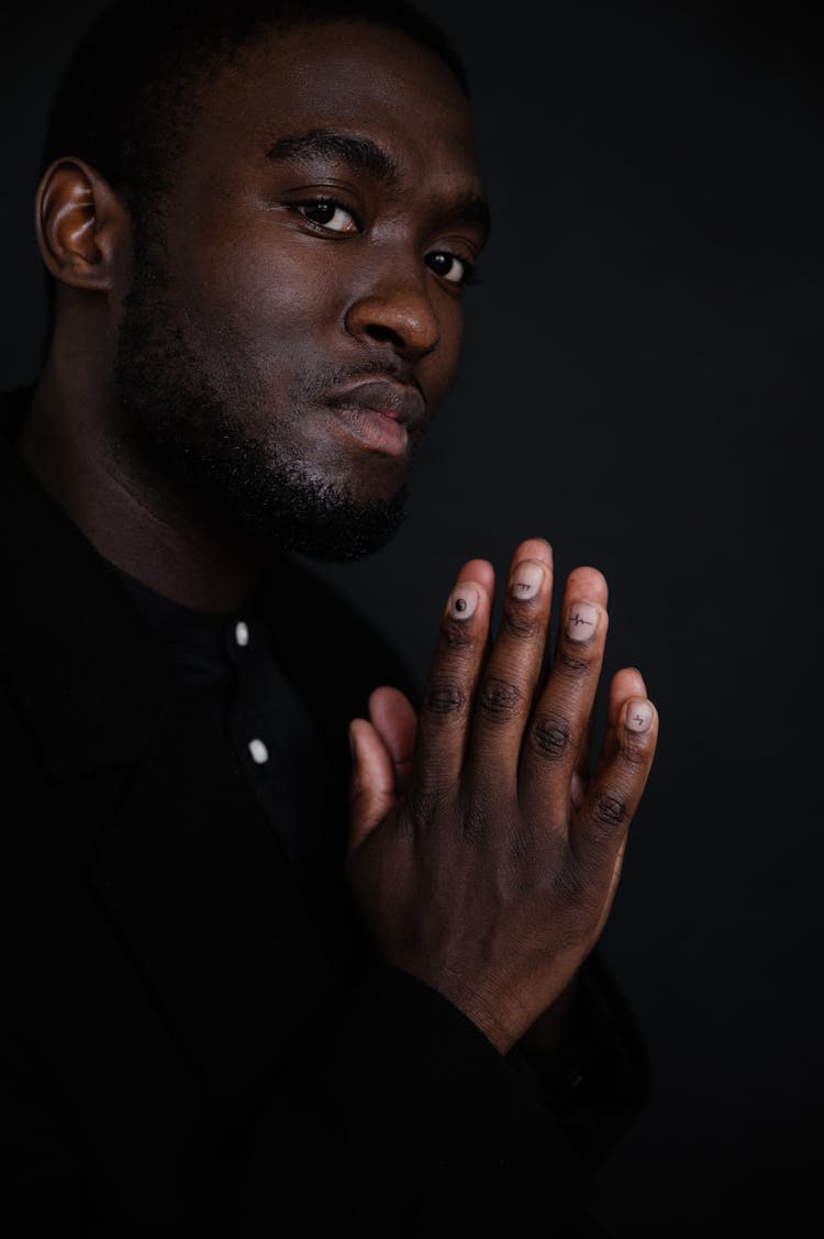 Portrait Pf Serious Black Man With Hands Near Chest