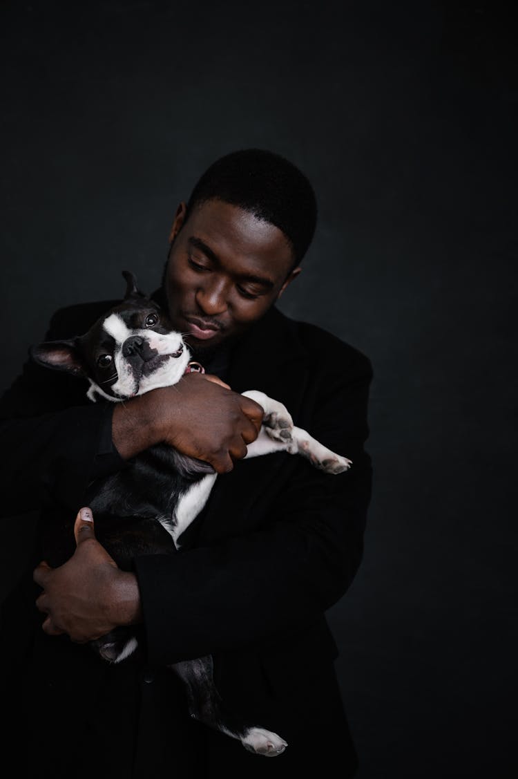 African American Man Holding Dog