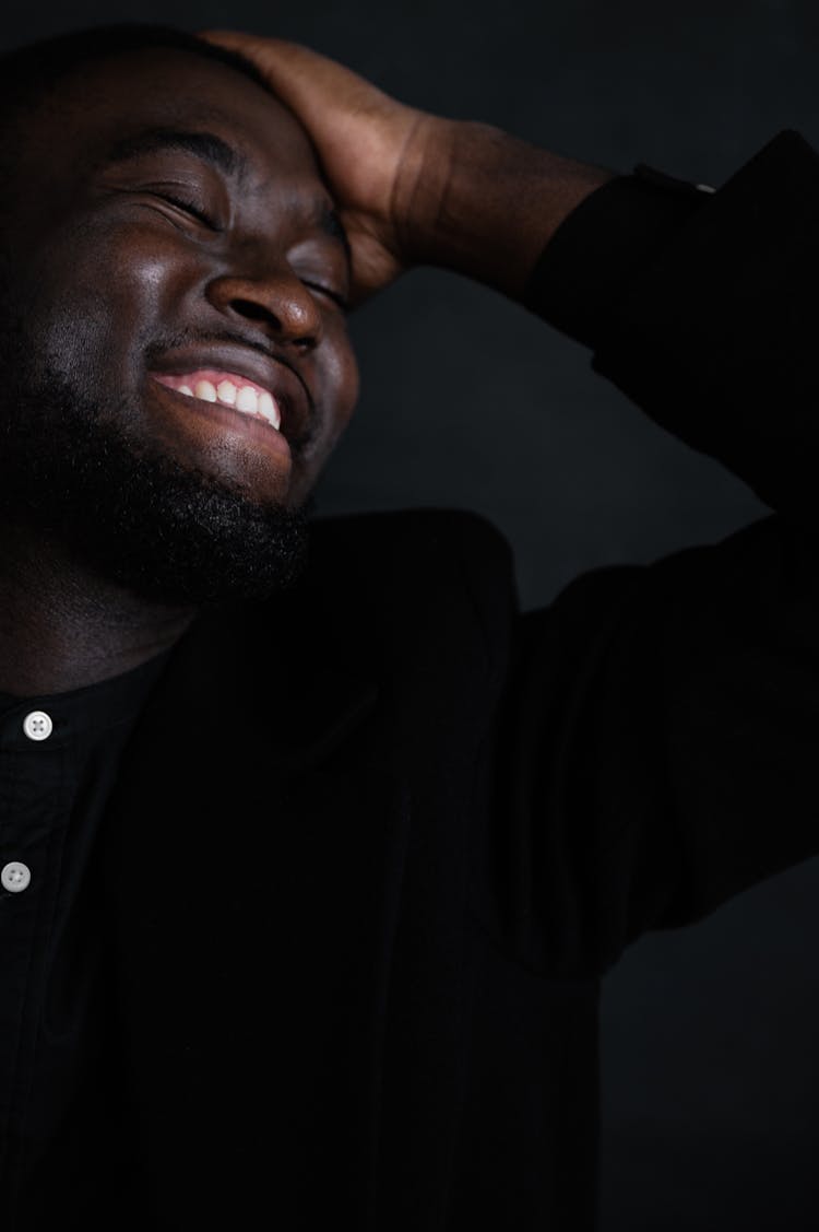 Black Man With Hand On Head Smiling