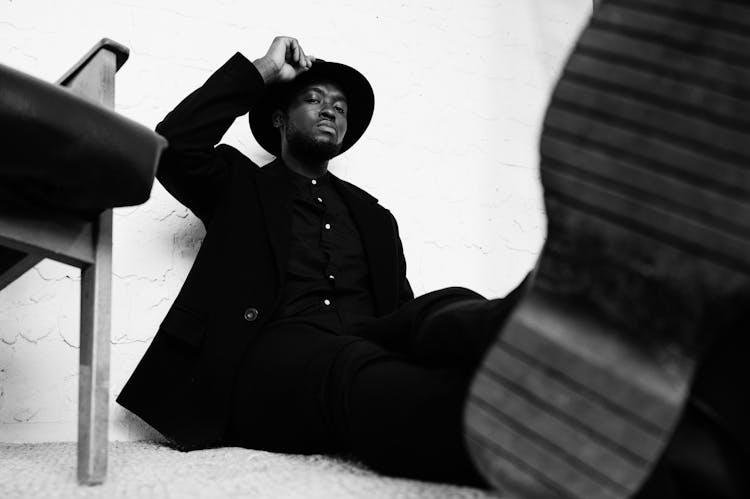 Thoughtful Black Man Sitting On Floor