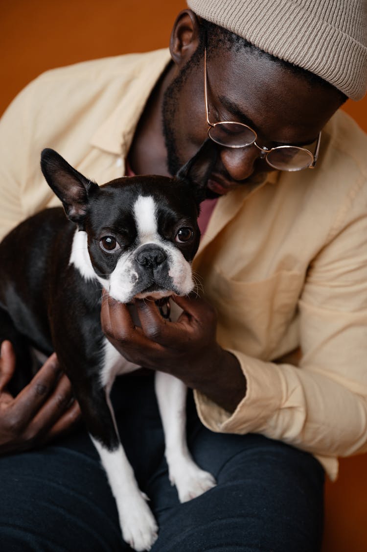 Black Man With Dog Sitting On Floor