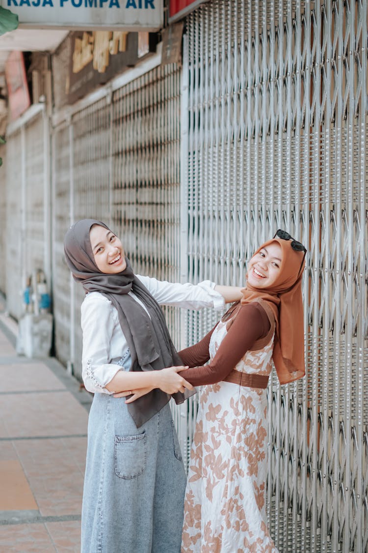 Women Posing Near The Steel Folding Gate