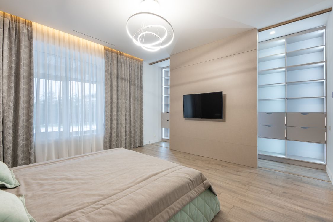Bedroom interior with TV set · Free Stock Photo