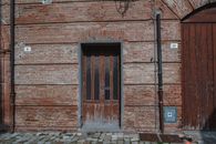 Brown Brick Building With Brown Wooden Door