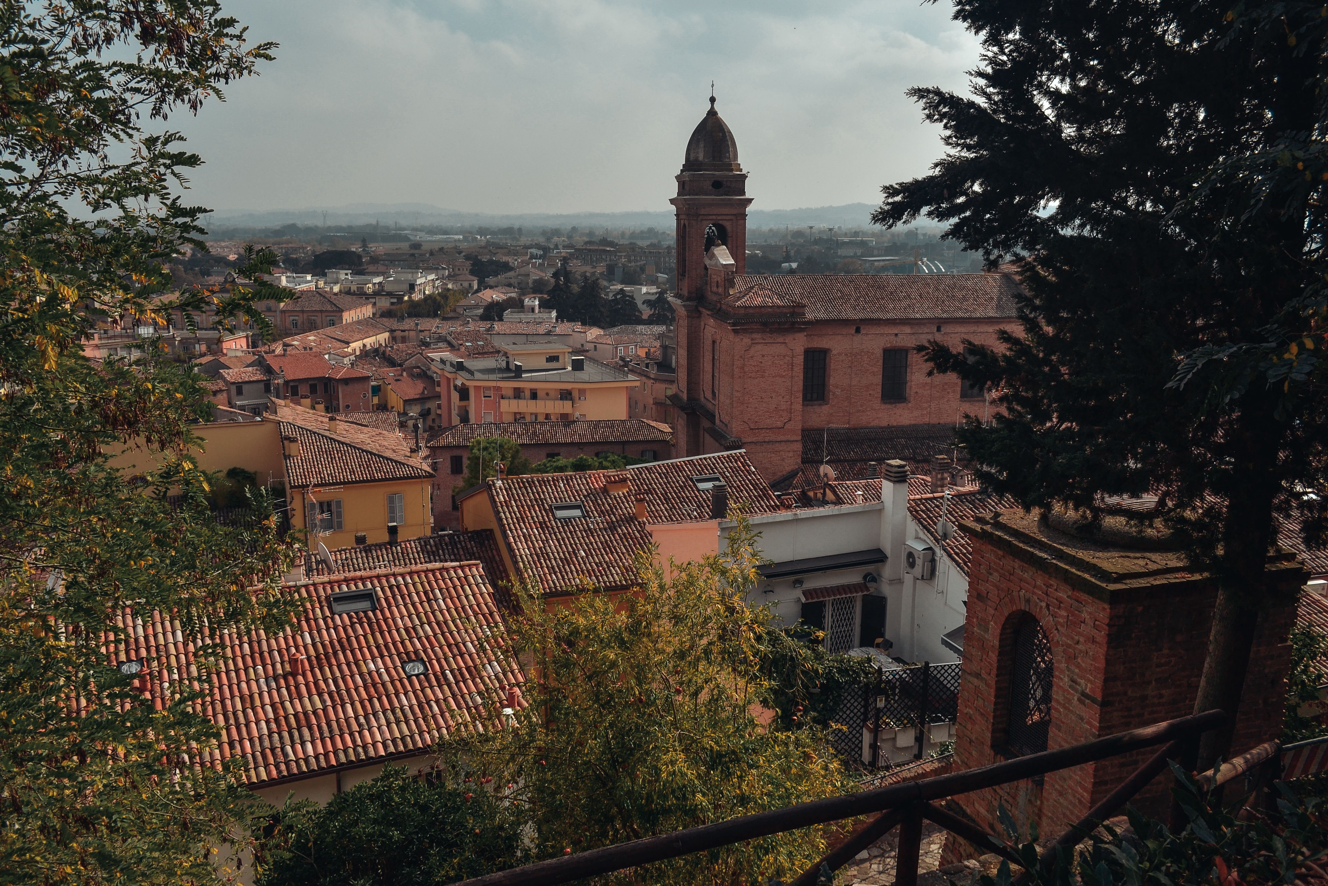 Aerial view of Santarcangelo di Romagna with historic architecture and red-tiled roofs.