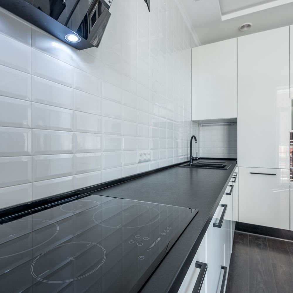 Kitchen Spraying in Brent Cross — clean edges cut in around trim and sockets