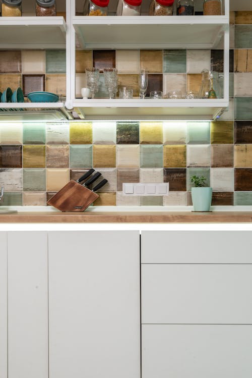 Bright kitchen counter with utensil against tiled wall