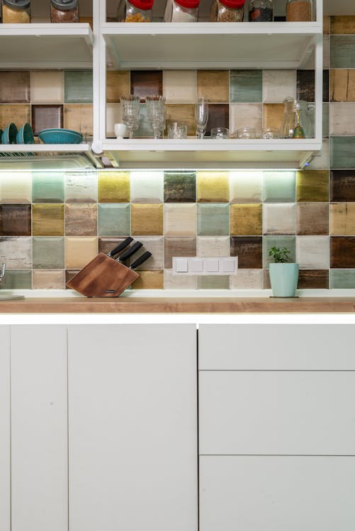 Bright kitchen counter with utensil against tiled wall