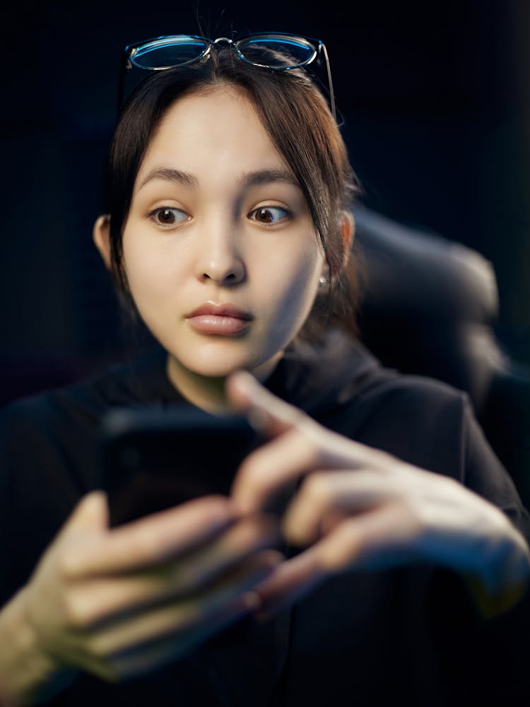 Woman In Black Top With Eyeglasses On Her Head