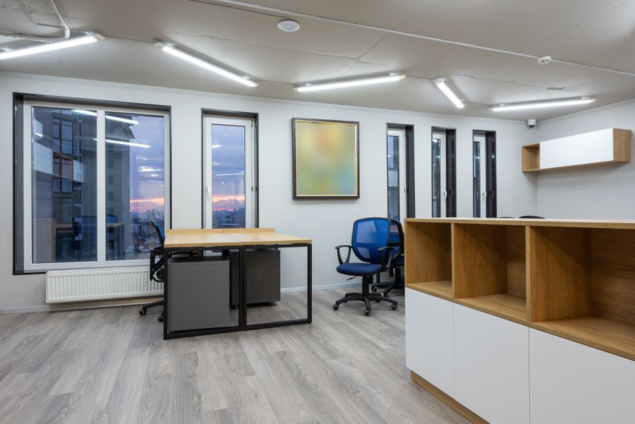 Open office with timber tables, task chairs and pendant lighting