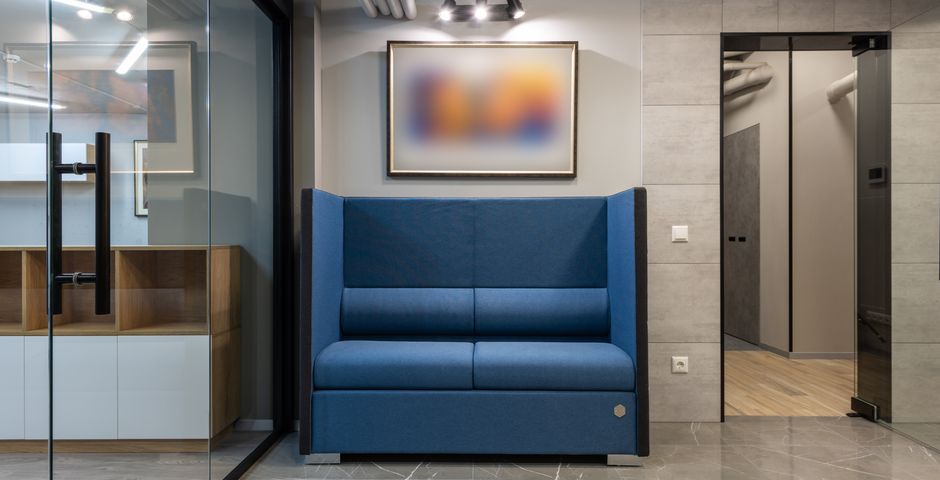 A comfortable fabric sofa in a contemporary shared lounge — soft breakout furniture is the harbourage operators overlook