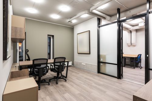 Free Stylish interior of spacious office with black chairs and wooden tables designed in minimal style Stock Photo