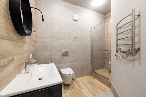 Contemporary interior of bathroom with shower and toilet designed in minimal style in new apartment