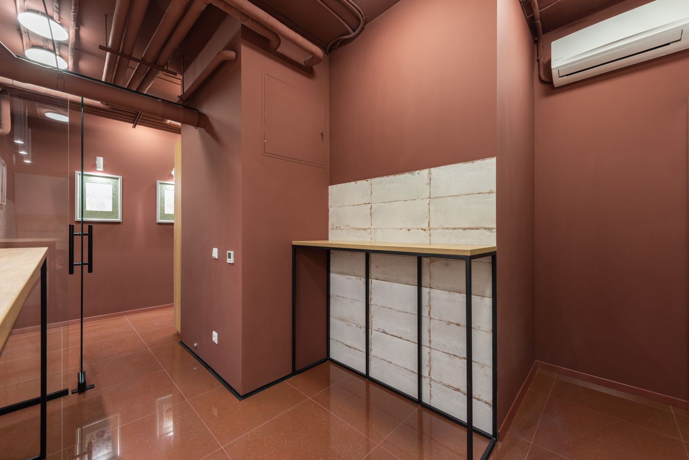 Fit-out in progress with exposed services, painted walls and a raw block counter
