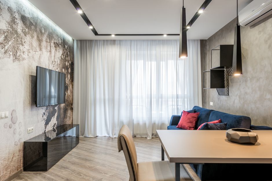 Stylish modern living room with minimalist decor, featuring a sleek sofa and elegant lighting.
