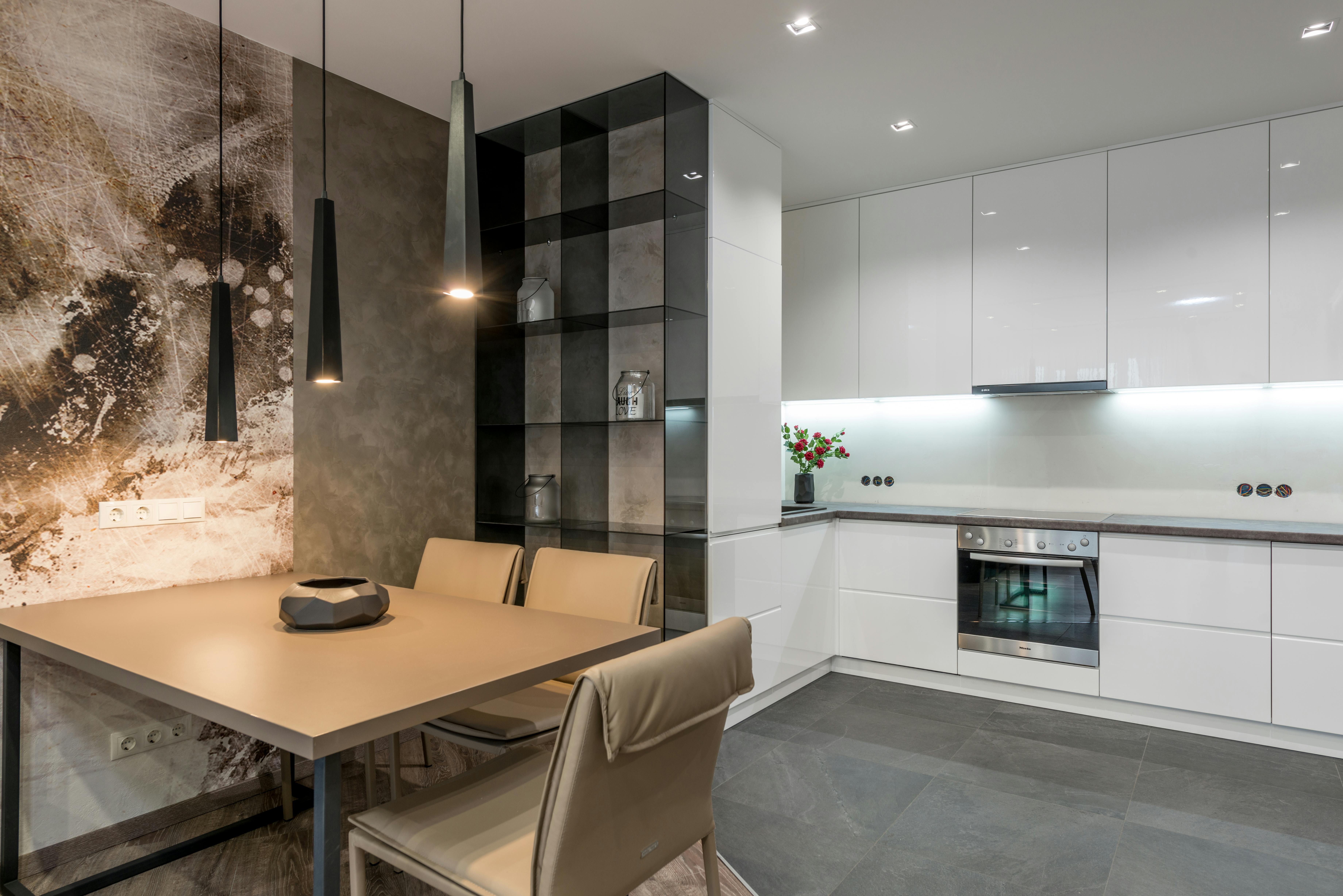 interior of modern kitchen with creative lamps and dining zone