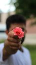 Unrecognizable ethnic man holding flower