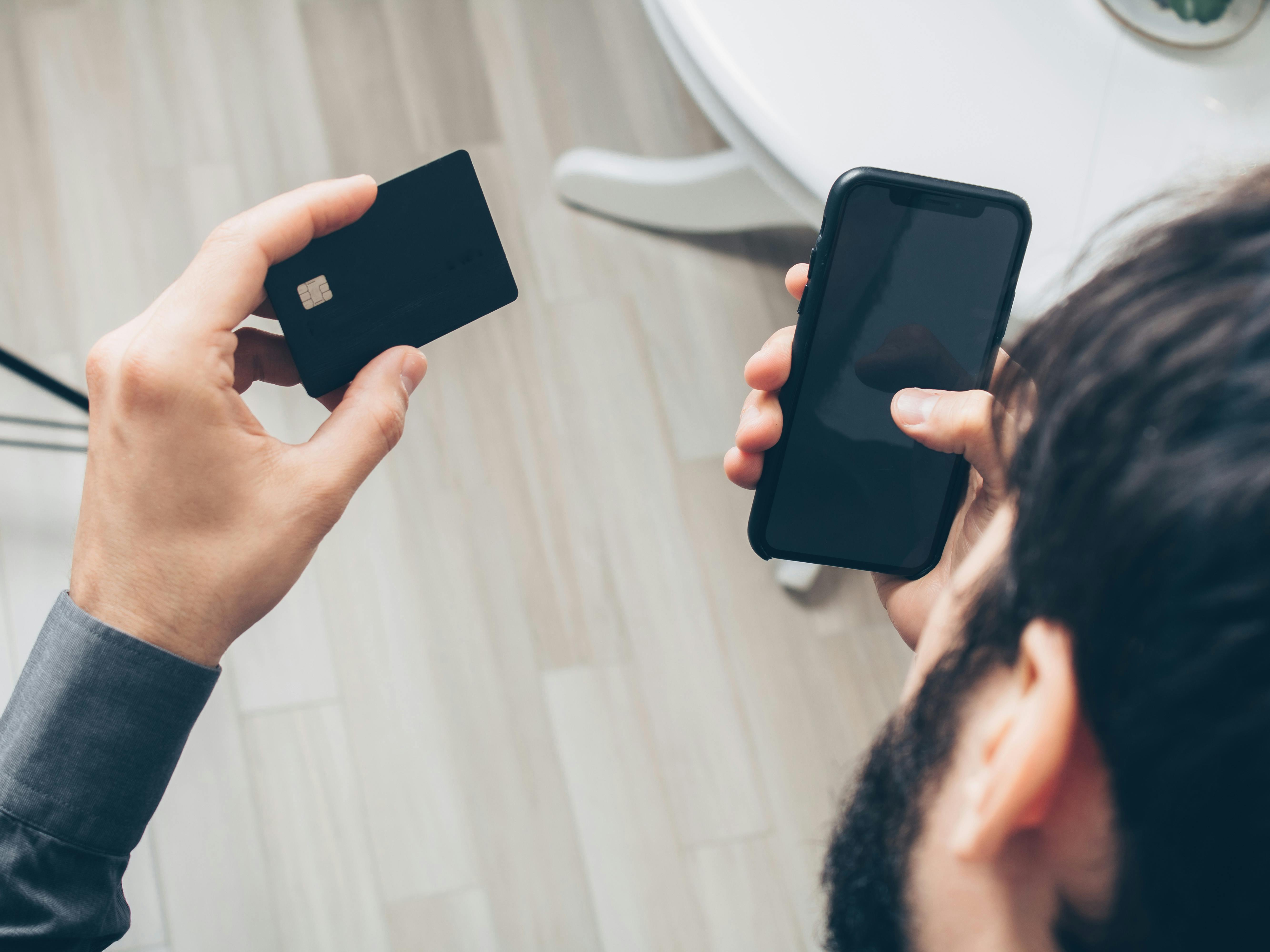 person holding black iphone