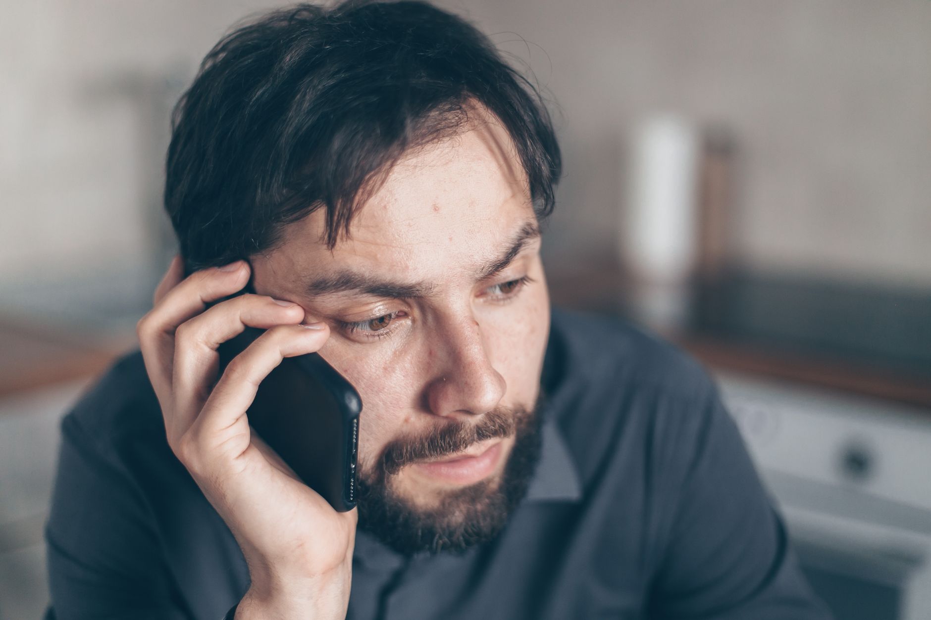 confused client holding phone questioning