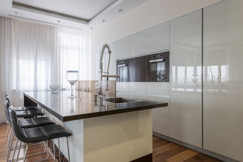 Minimalist interior of spacious kitchen with built in ovens and island