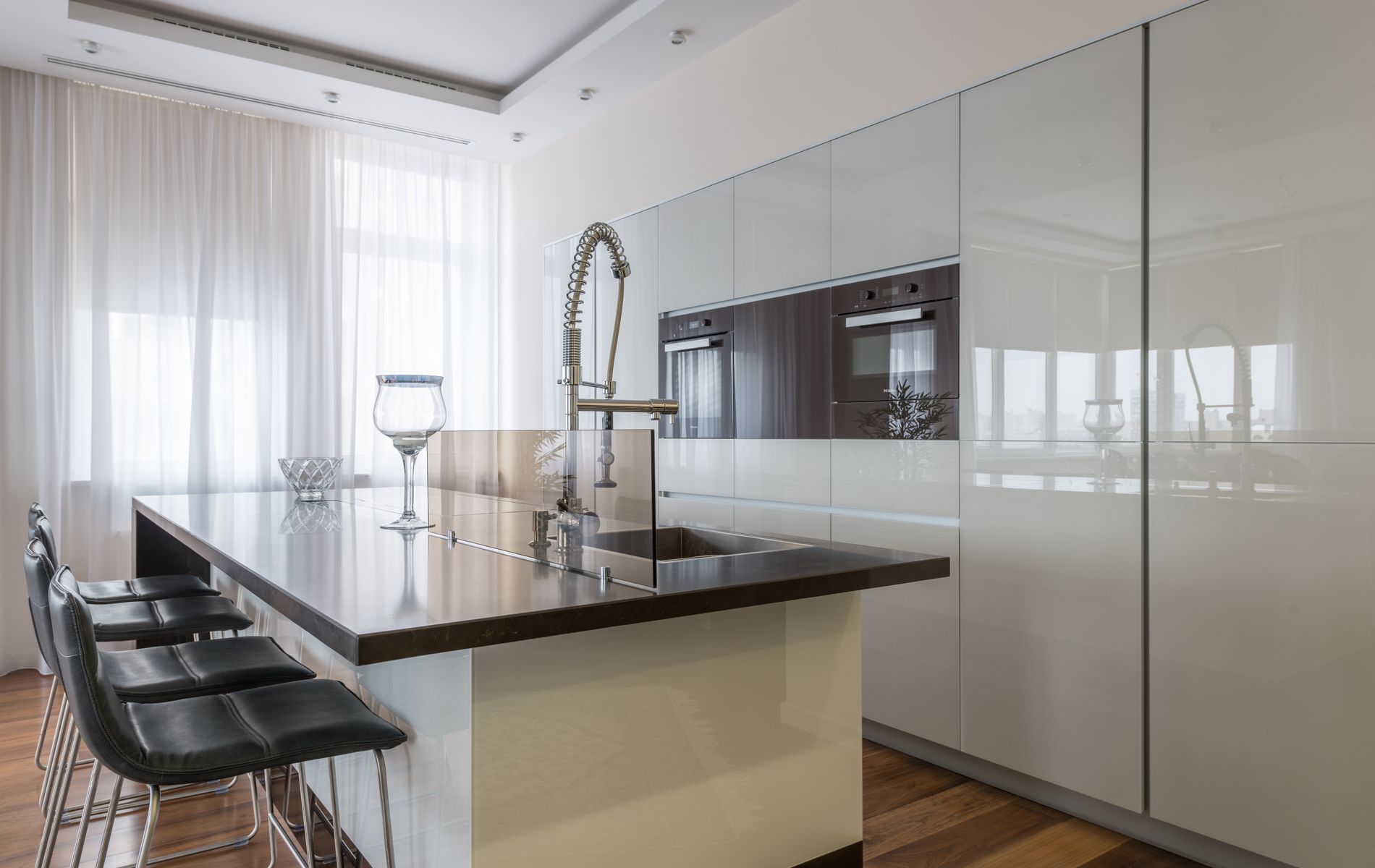 Custom kitchen island with waterfall countertop and seating installed in Orange County