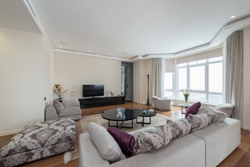 Interior of spacious living room with comfy sofas and parquet floor