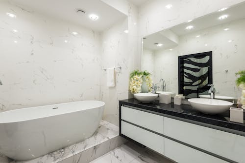 Interior of modern bathroom with white walls and bathtub