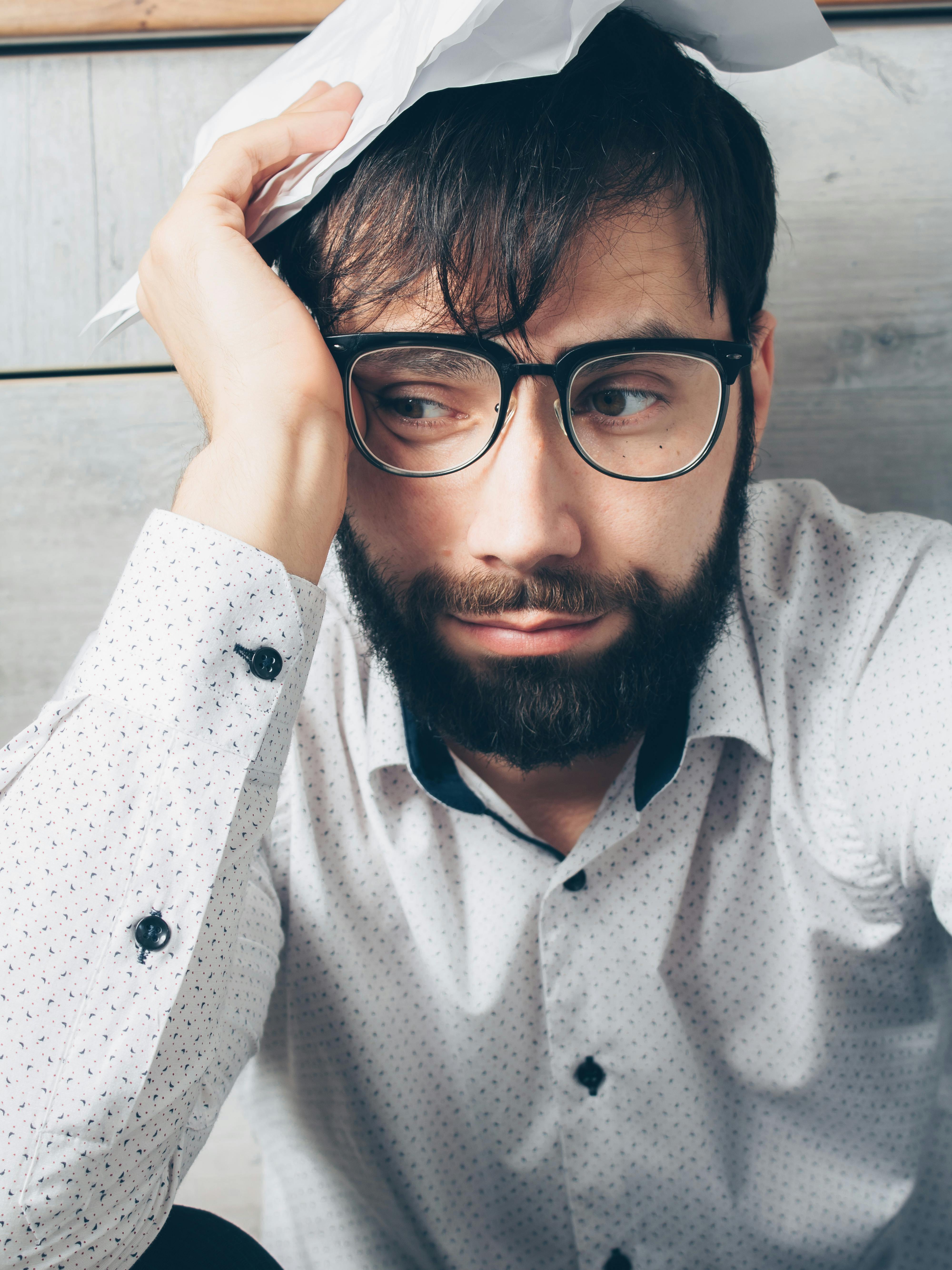 man in white button up shirt wearing black framed eyeglasses