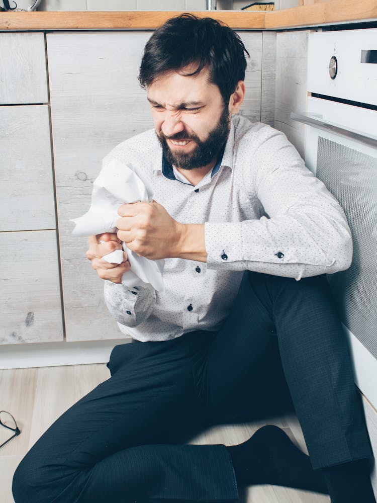 An Angry Man Crumpling A Paper