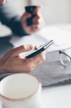 Hands holding a smartphone and credit card for online payment, emphasizing cashless transactions.