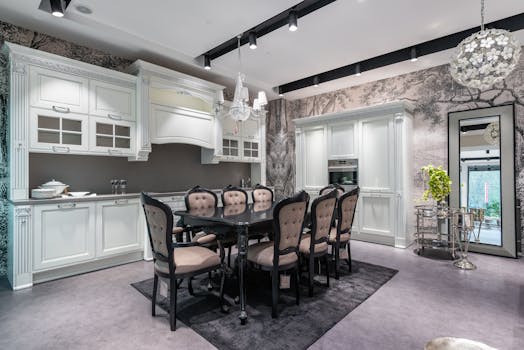 Spacious kitchen with classic decor, white cabinetry, and chic dining area.