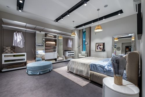Free Interior of design of modern bedroom with gray walls and hanging lamps carpet and wardrobe Stock Photo