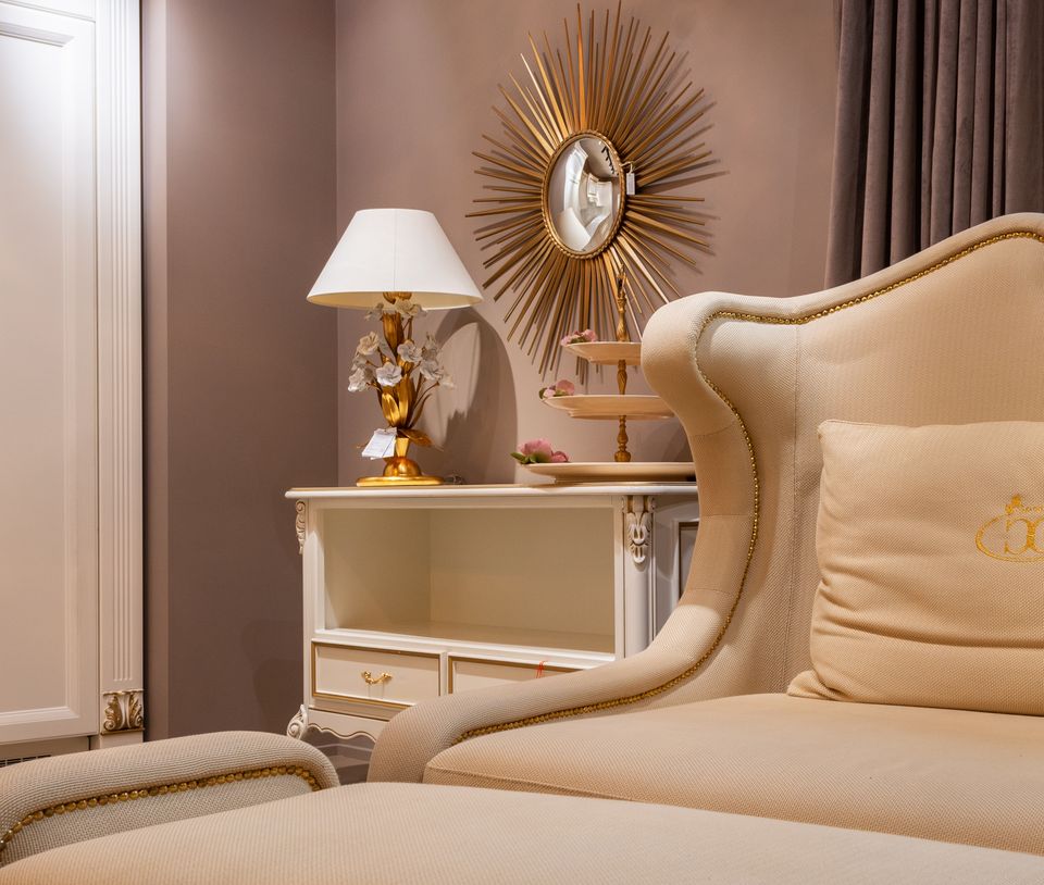 Convertible beige sofa-cum-bed in a furnished room