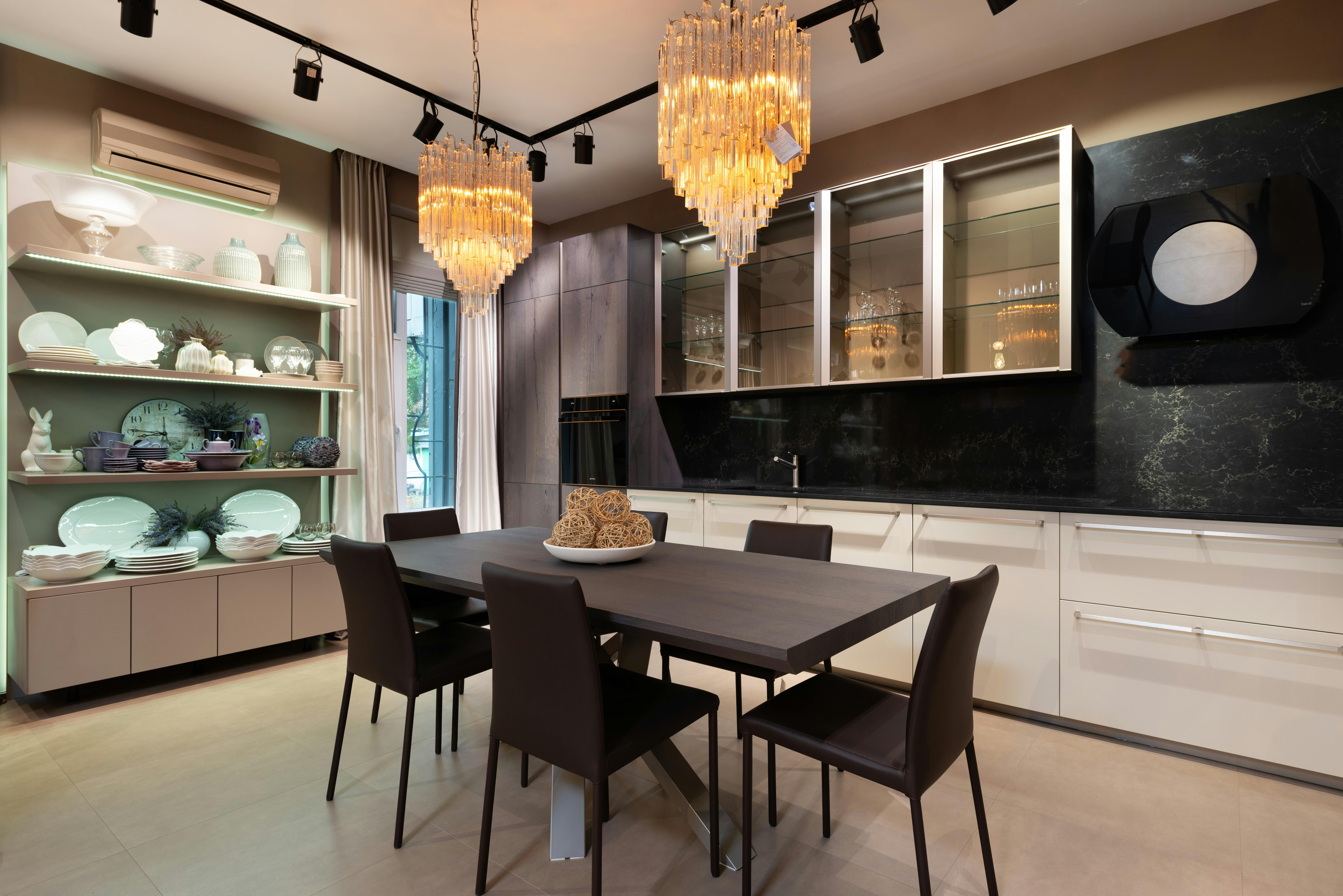 stylish interior of modern kitchen with crystal chandeliers and wooden furniture