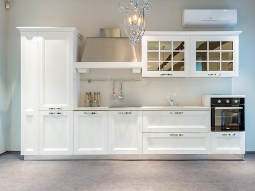 Free White kitchen furniture and modern appliances in apartment Stock Photo