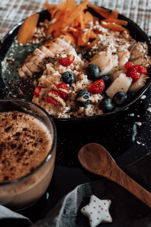 Free Appetizing breakfast bowl with fruits, oatmeal, and coffee for a nutritious start to the day. Stock Photo