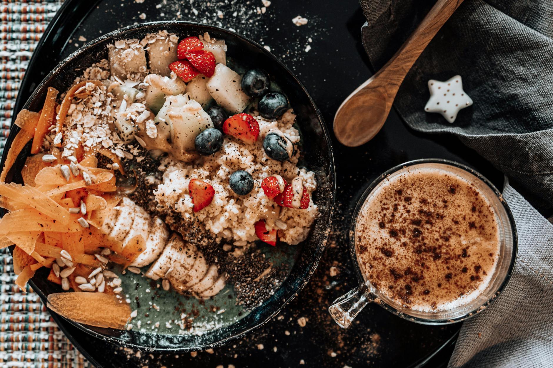 Delicious oatmeal breakfast bowl with fresh fruits and a cup of coffee.