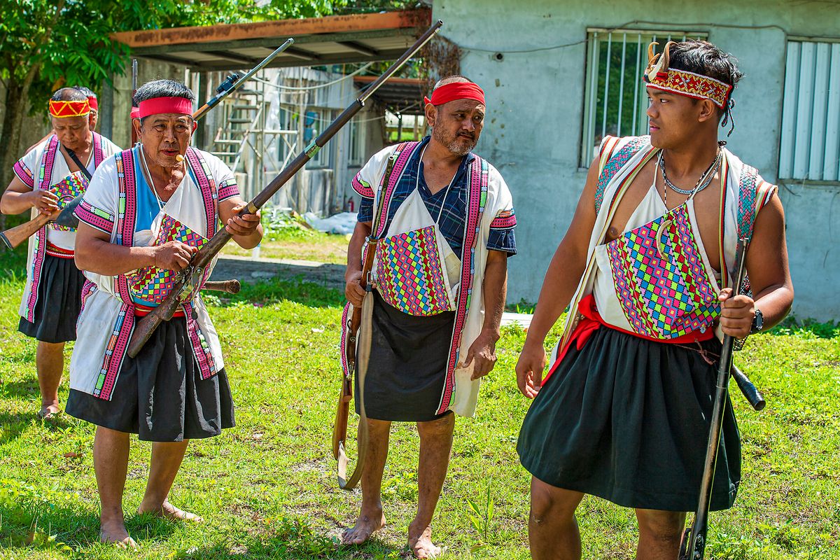 Indigenous Taiwanese cultural performers in traditional dress at the Formosan Aboriginal Culture Village