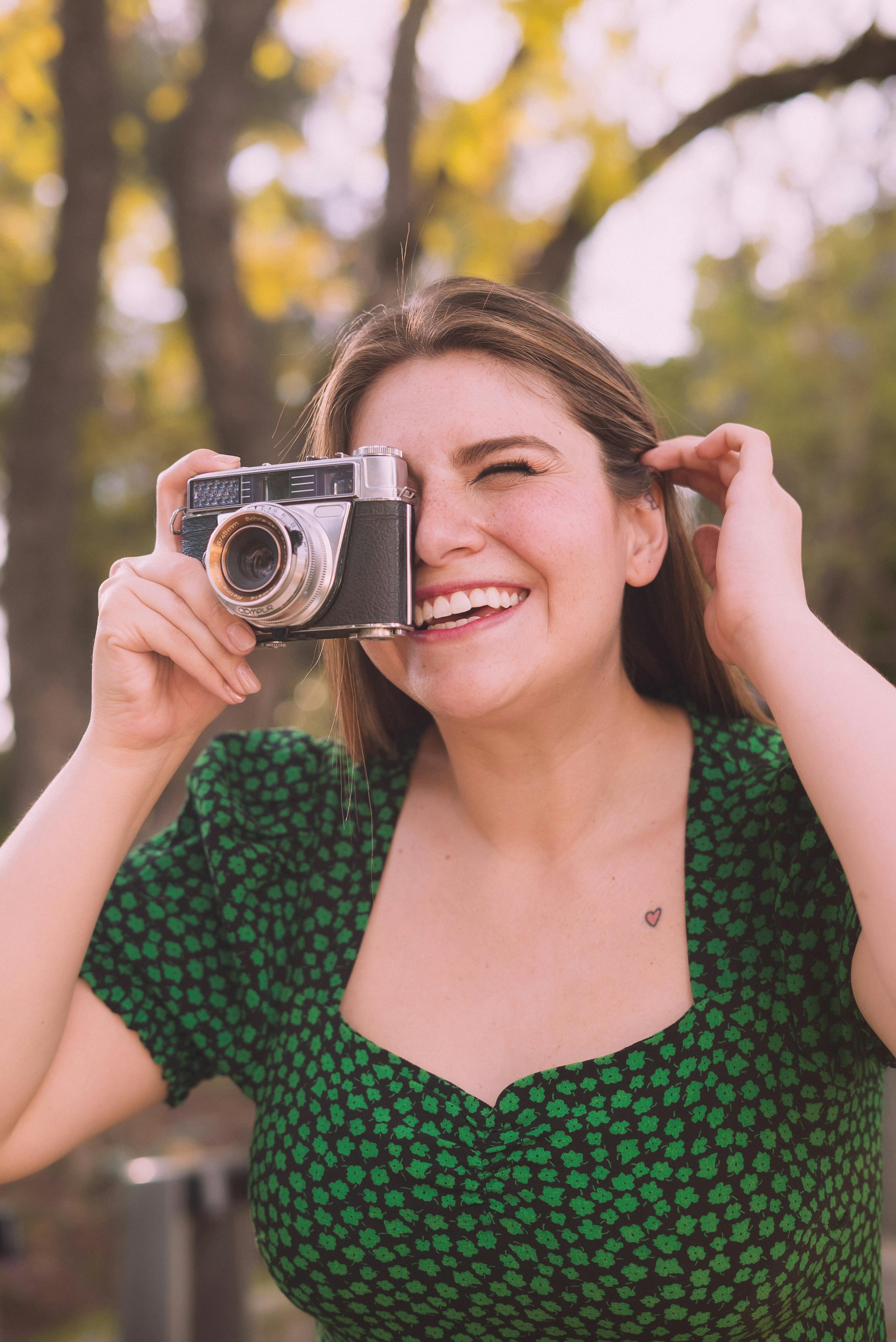 a woman taking a picture with a camera