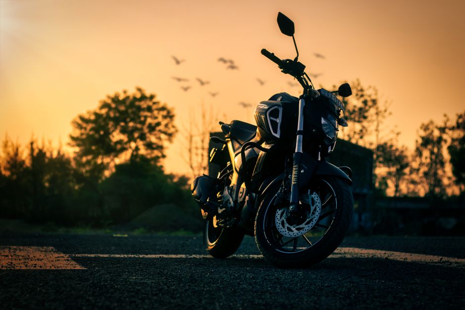 A striking sports motorbike at sunrise with a serene Indian backdrop.