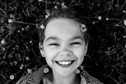 A Grayscale of a Girl Smiling