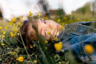 A Woman Lying on Ground of Yellow Flowers