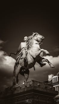 Striking sepia-toned equestrian statue under cloudy Copenhagen sky.