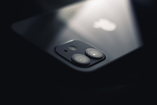 Close-up shot of a smartphone camera lens reflecting light, highlighting modern technology.